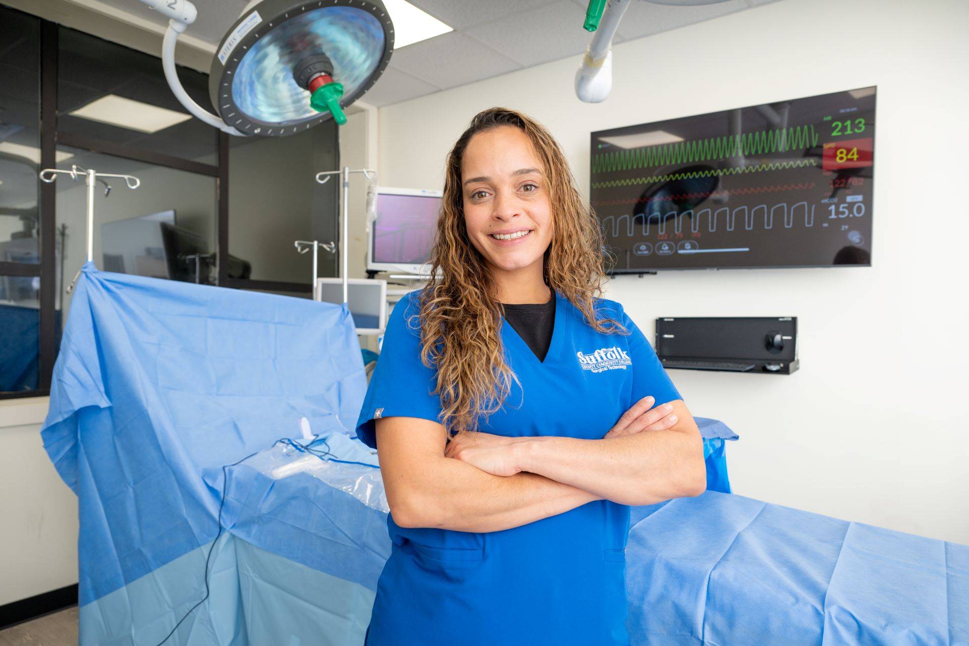 Woman in Suffolk nurse scrubs near operating table