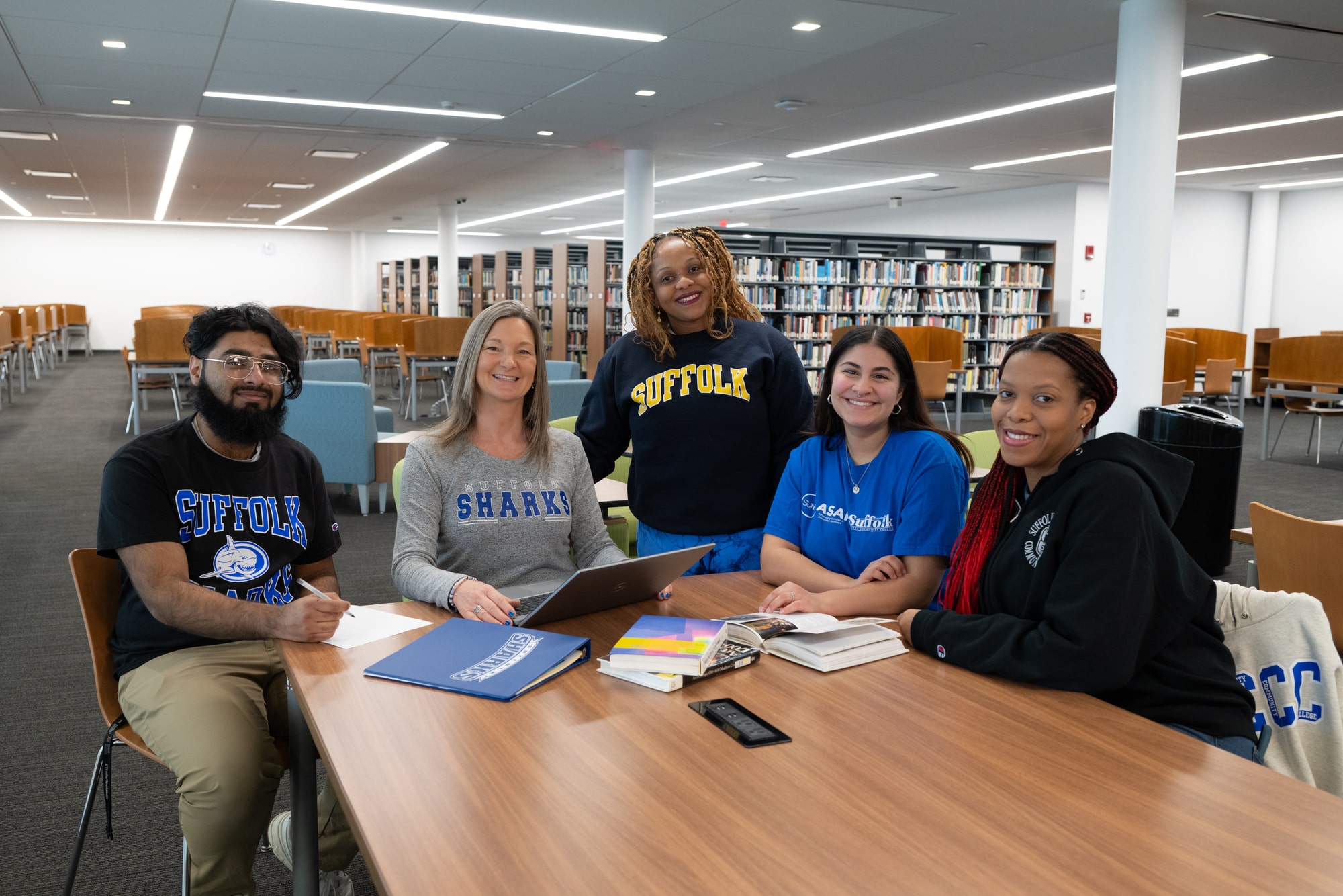 Group of five students in the campus library at the Michael J. Grant campus in Brentwood.
