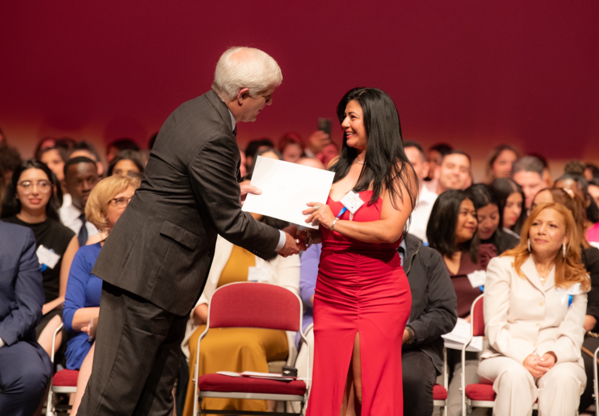 Dr. Bonahue presenting a completion certificate to an ESL student.
