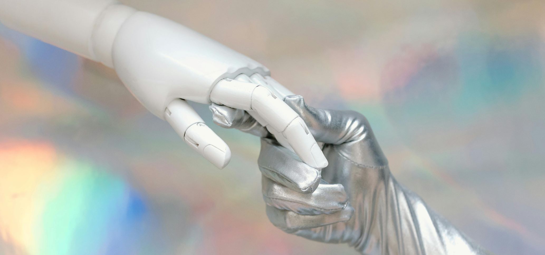 human hand holding a robot hand