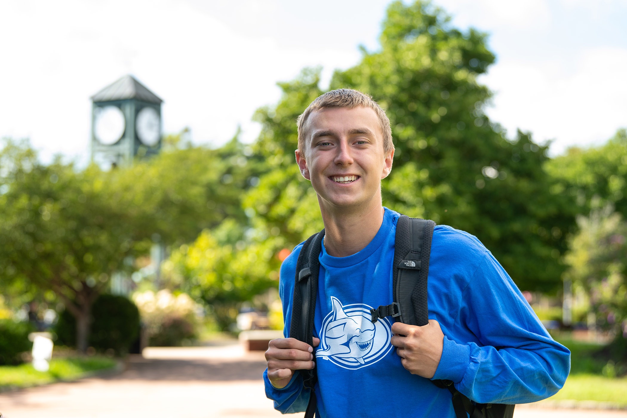 A student outside a building on college campus.